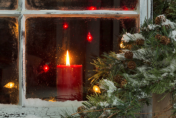 photo of red candle burning in window at Christmas