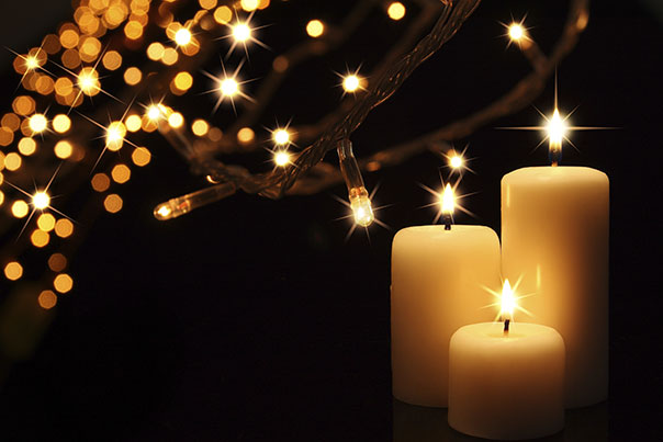 photo of three lit candles and starry lights